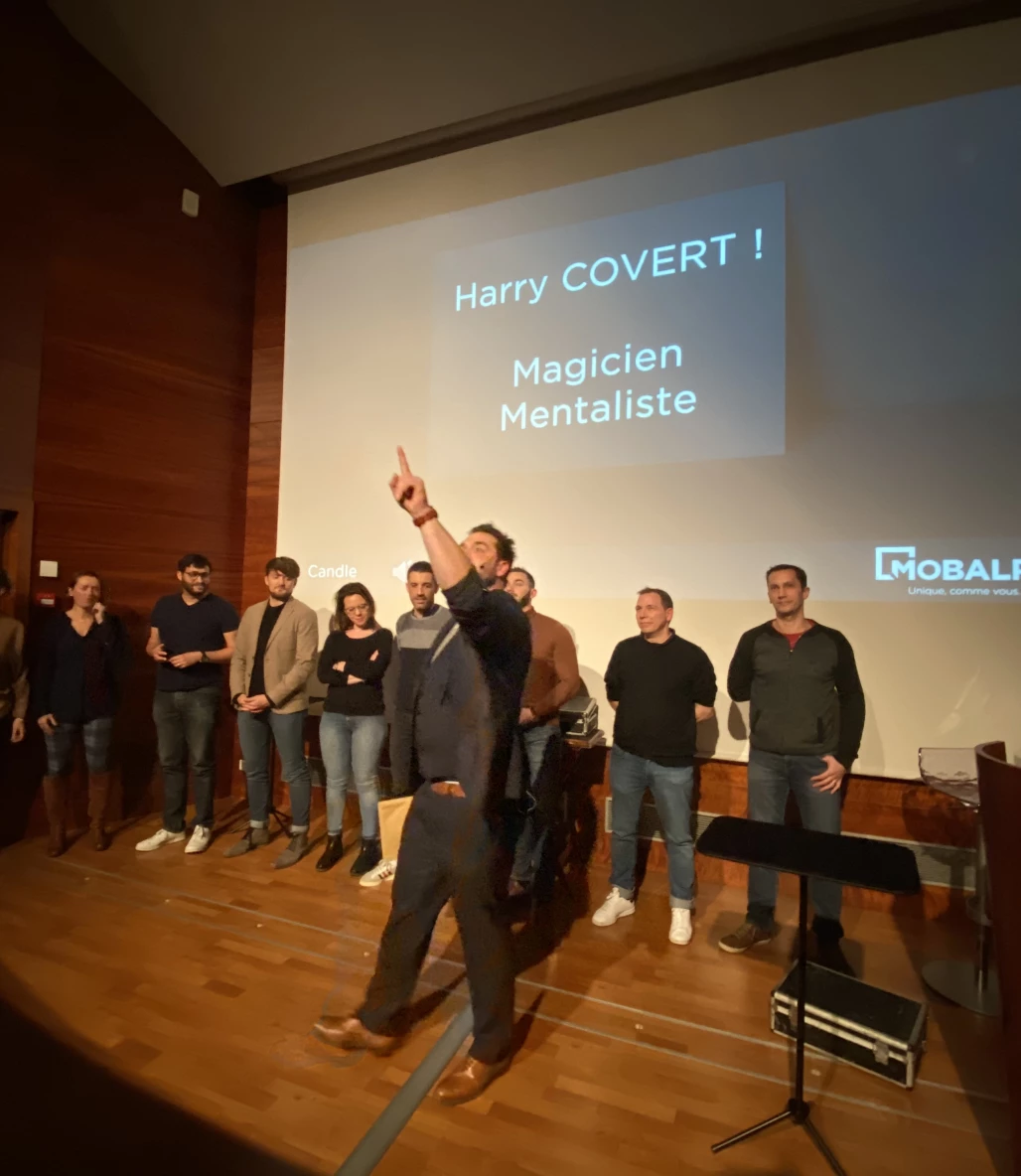 Harry Covert surrounded by volunteers during a corporate mentalism show