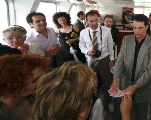 Harry Covert rÃ©alise un tour de cartes entourÃ© dâinvitÃ©s lors dâune rÃ©ception